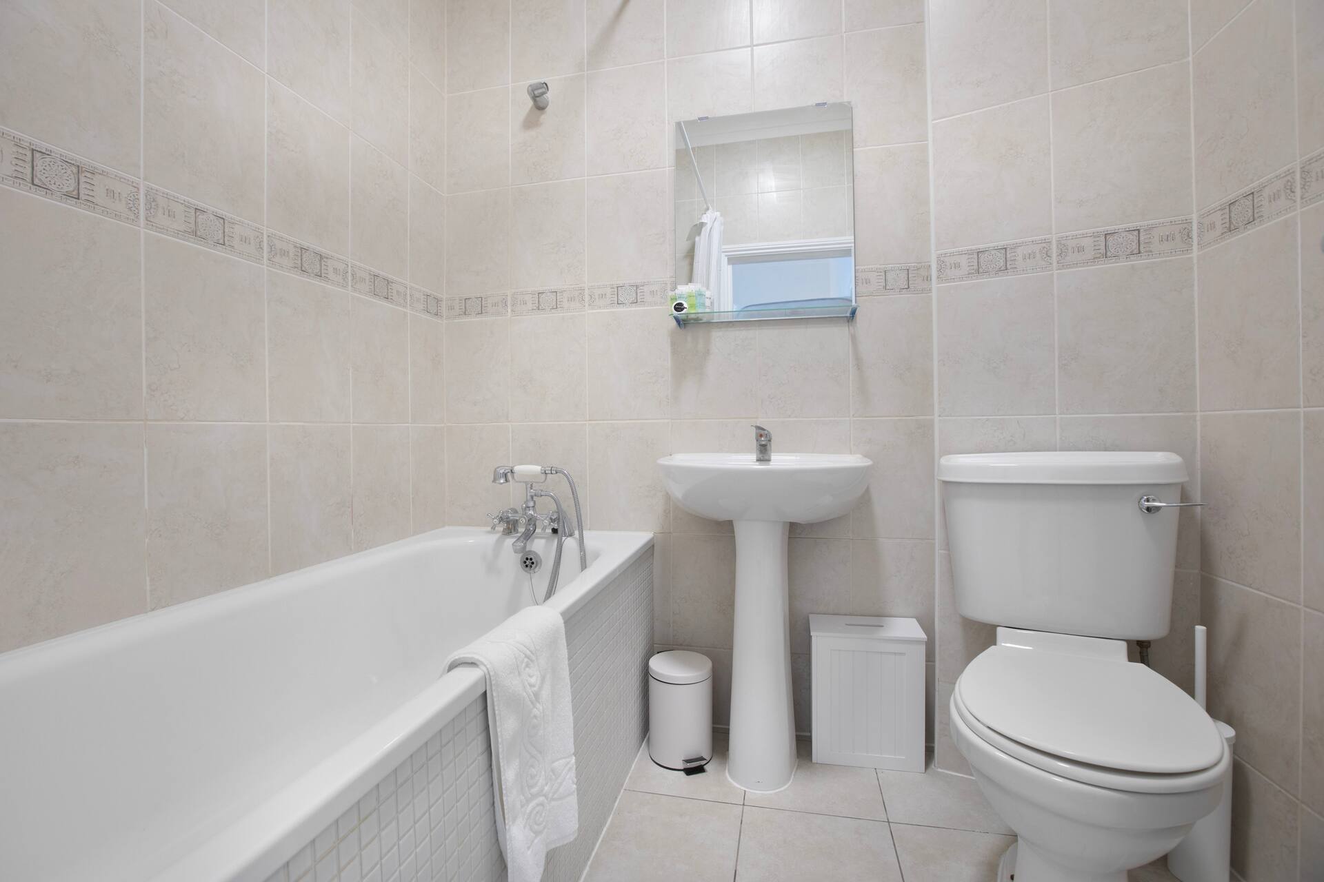 Main bathroom with bathtub, sink and traditional fixtures