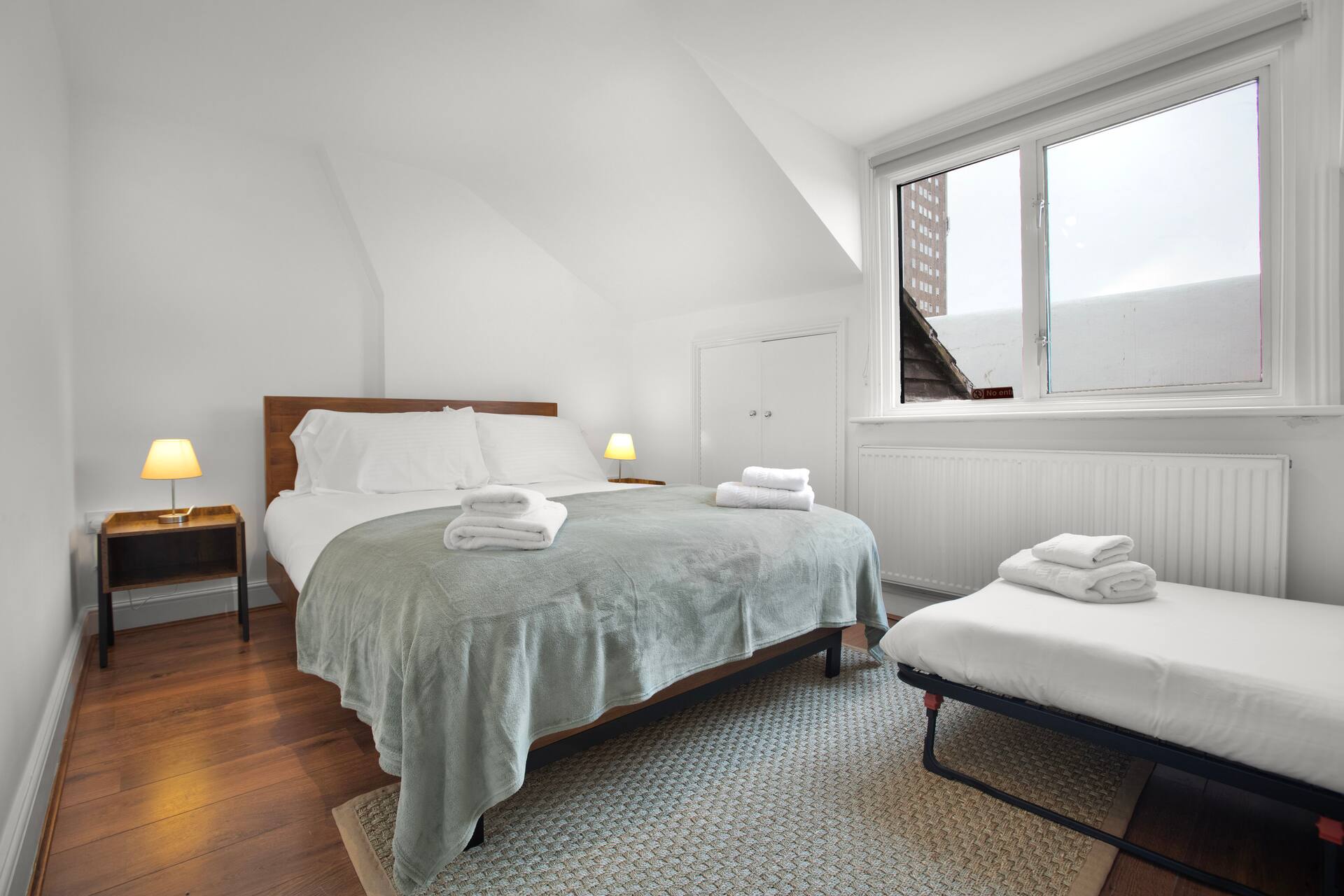 Spacious loft bedroom with sloped ceilings and natural light