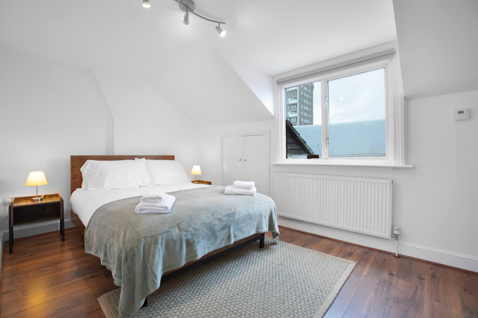 Loft bedroom with attic character and city views