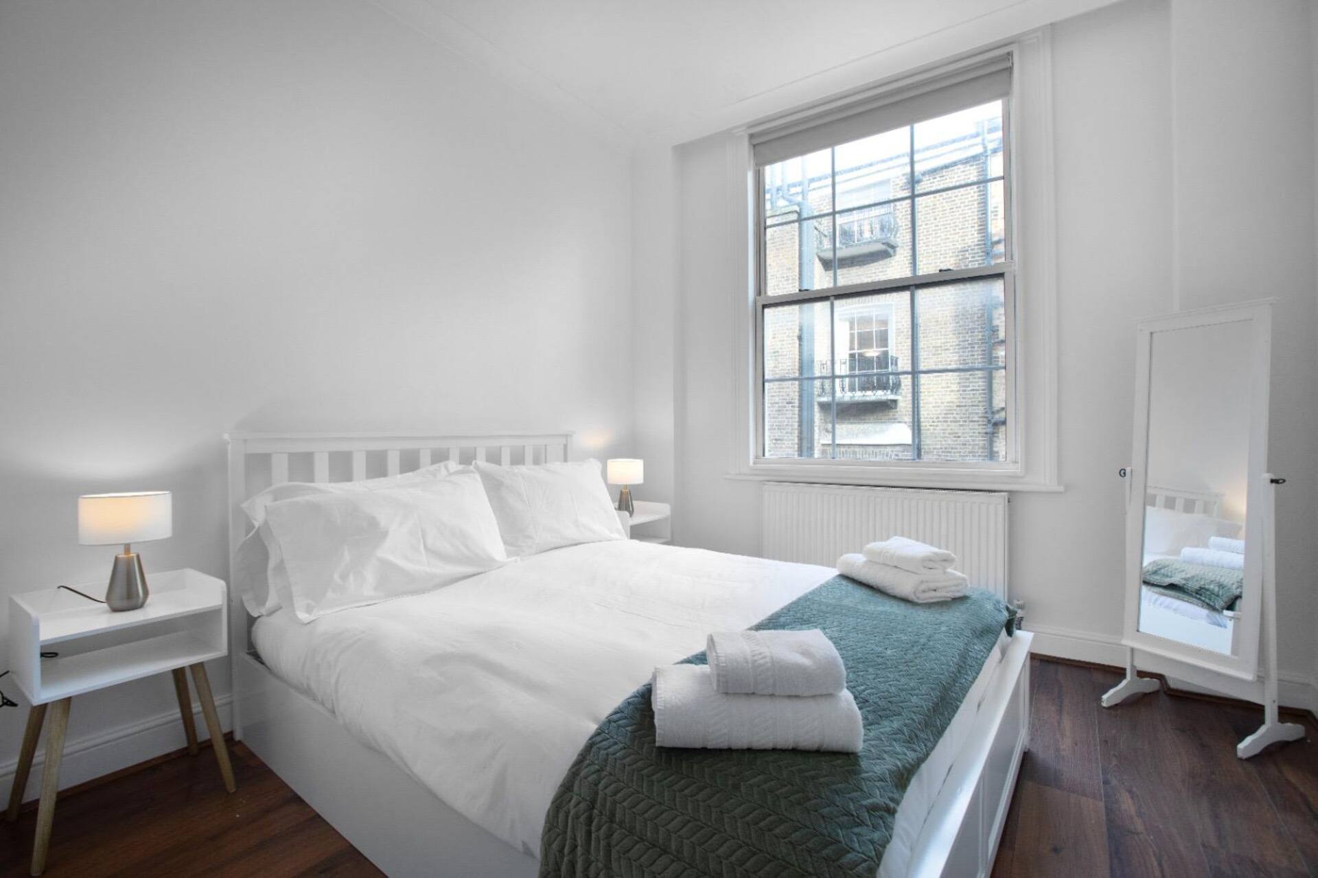 Third bedroom with white furniture and bright interior