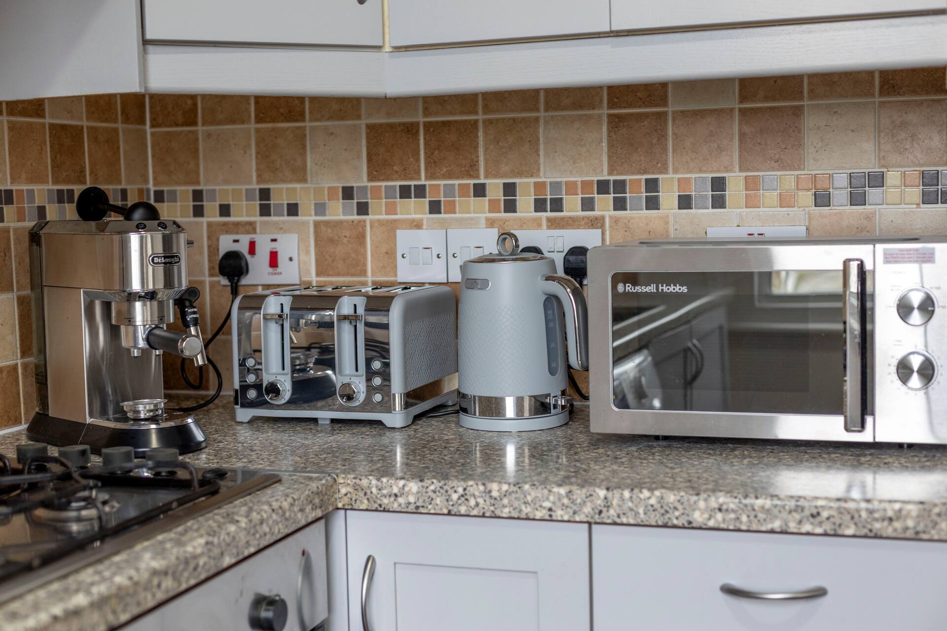 Premium kitchen appliances including espresso machine, toaster and microwave