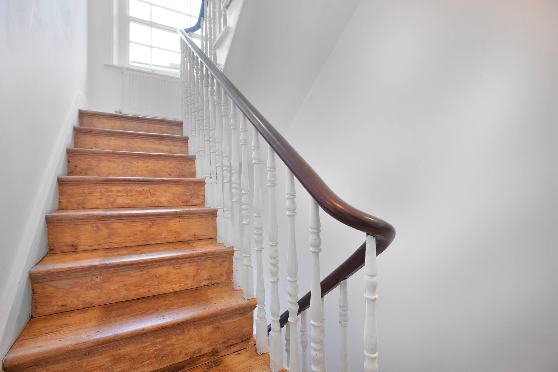 Traditional wooden staircase with mahogany banister